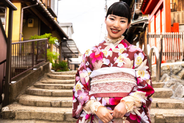istock A woman in a kimono walking around town 2176662671