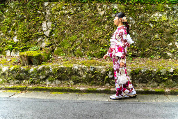 istock A woman in a kimono walking around town 2176662709