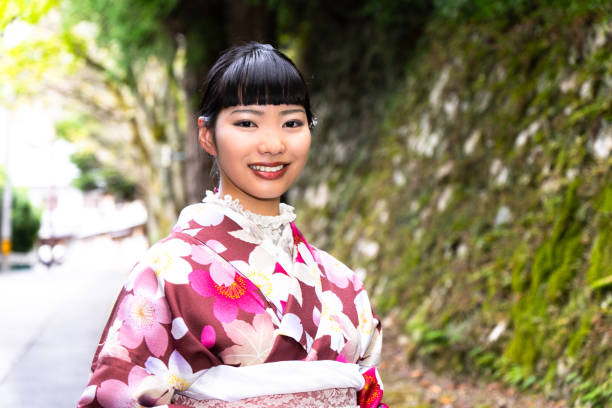 istock A woman in a kimono walking around town 2176662785