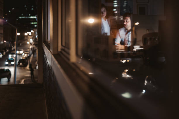 istock Two businesspeople working late at night inside of an office 2176664172