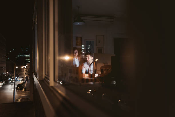 istock Two businesspeople working inside of an office late at night 2176664376