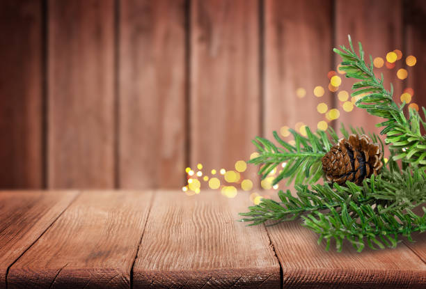 istock Christmas Tree Branches and Pine Cone on Old Wooden Table 2176664466