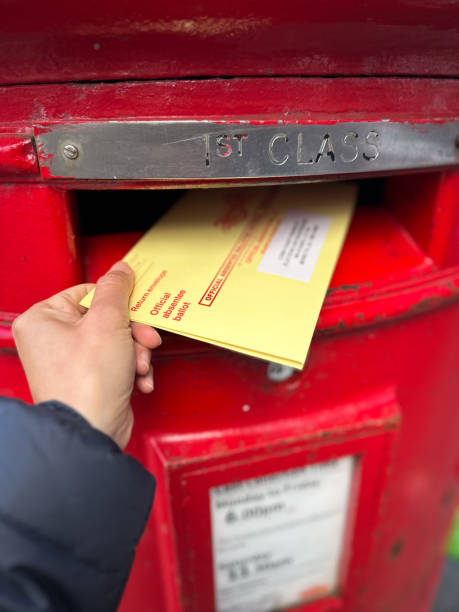 istock Woman Hand Posting Her Absentee Voter Ballot 2176664487