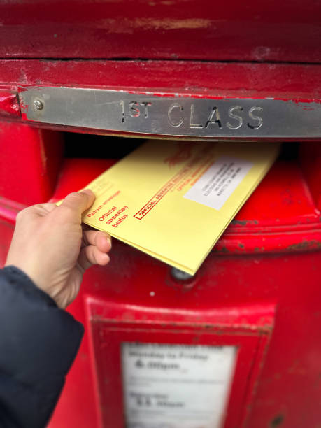 istock Woman Hand Posting Her Absentee Voter Ballot 2176664488