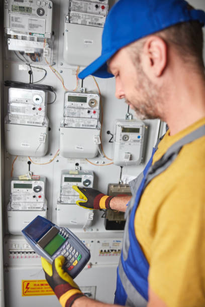 istock Technician reading consumption and charging on a wireless electricity power meter station in a building. 2176664585