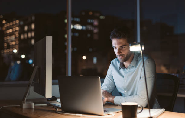 istock Young businessman working overtime late in the evening 2176666618