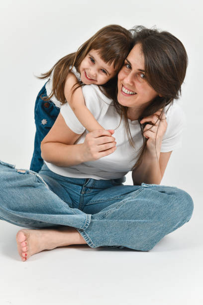 istock Cute Smiling Toddler Leaning on Mother's Back While Both Laughing and Looking at Camera 2176670266