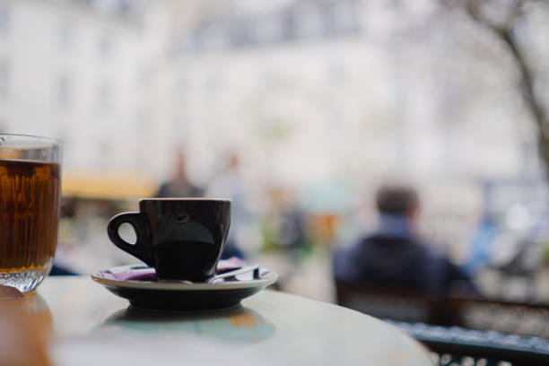 Outdoor view of a charming yellow café in Bordeaux, France, with people enjoying coffee and conversation. The inviting atmosphere reflects French culture and a lively street ambiance.