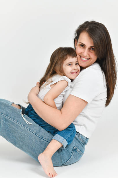 istock Mother and Daughter Looking at Camera Smiling While Creating Memories Together 2176670694