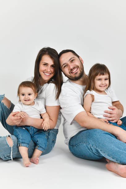 istock Happily Married Mother and Father Enjoying Their Time With Two Young Daughters 2176670737