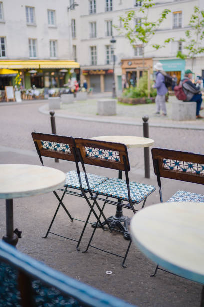 istock Folding Chairs on a Small Round Table Standing Outside of a Restaurant on the Sidewalk 2176671140