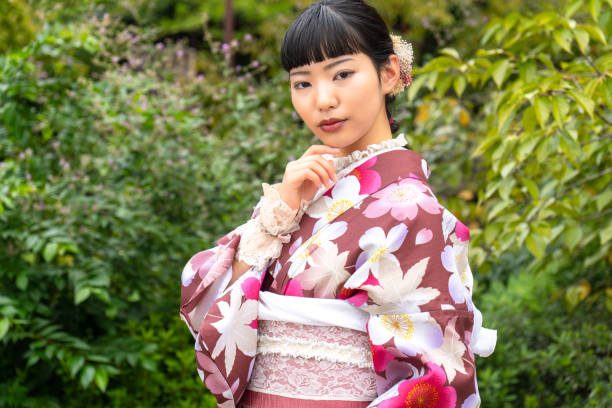 istock A woman in a kimono walking around town 2176672654