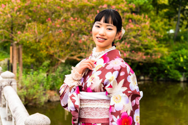 istock A woman in a kimono walking around town 2176672861