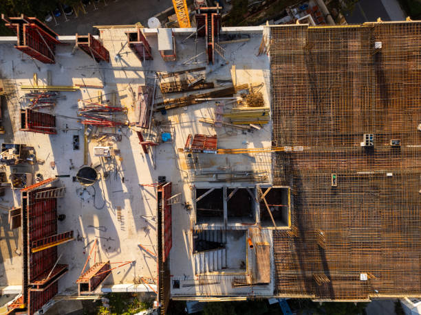 istock A drone video showcasing a top-down view of a construction site. The image captures the building's foundation, scaffolding, and materials, highlighting the early stages of architectural development 2176673694