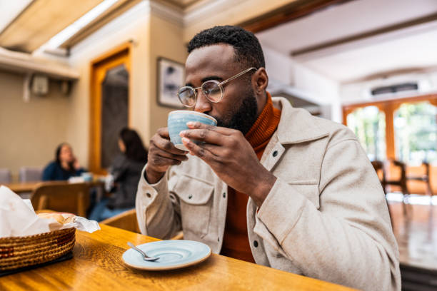istock Mid adult man drinking coffee on a coffee shop 2176673948