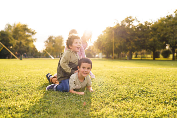 Group of happy boys and girls having fun playing in nature