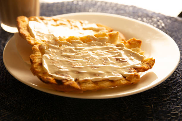 Toasted bread with melted butter, Brazilian breakfast food with cream cheese and coffee and milk