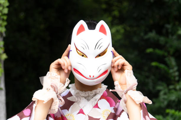 istock A woman in a kimono posing with a fox mask 2176675246