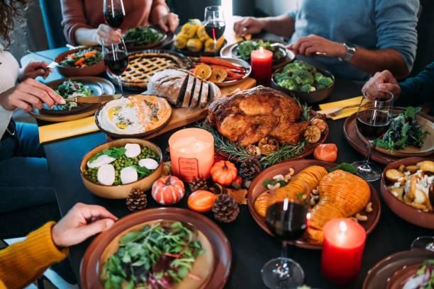 istock Happy family celebrating Thanksgiving at dining table. 2176675603