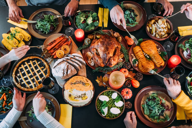 istock Happy family celebrating Thanksgiving at dining table. 2176675629