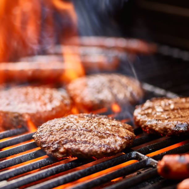 istock flame broiled hamburger patties cooking on grill 2176676643