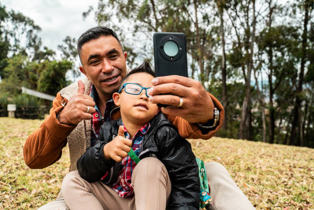 istock Father taking a selfie with son with down syndrome outdoors 2176677401