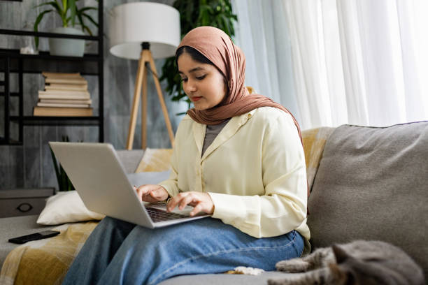 istock Woman typing on laptop with a calm and focused expression. 2176678623