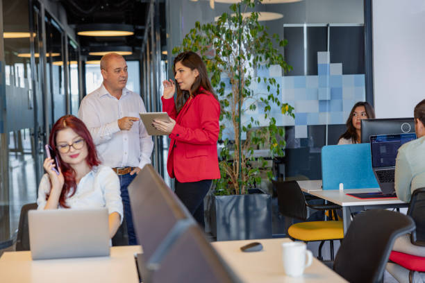 istock Business Colleagues Utilizing Digital Tablet for Work in a Modern Office Building 2176679148