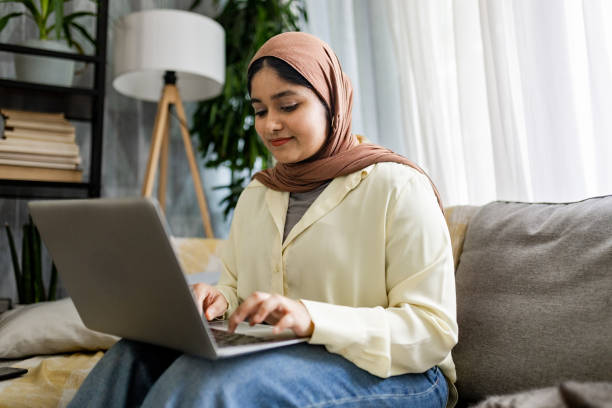 istock Young woman working on a laptop in a serene setting. 2176679348