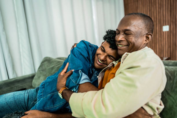 Father and son embracing at home