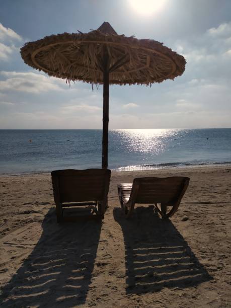 istock A sandy beach with loungers and umbrella 2176686524