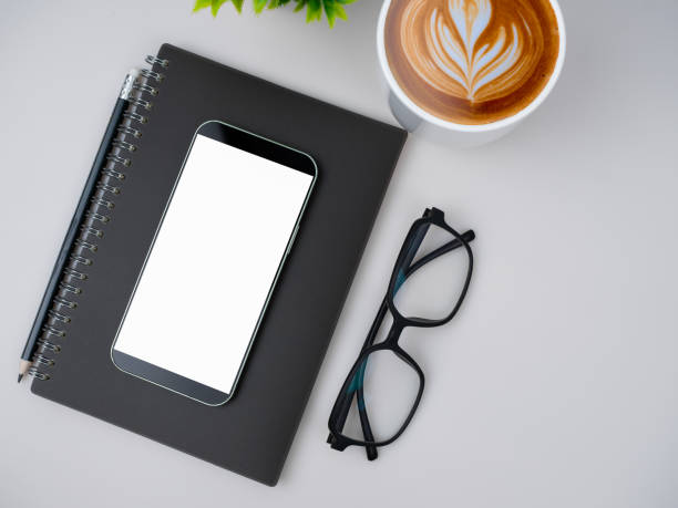 istock Top view of mock up modern workspace with blank screen smartphone, keyboard. Office situation with keyboard and accessories isolated on white. Copy space, Flat lay. 2176688122