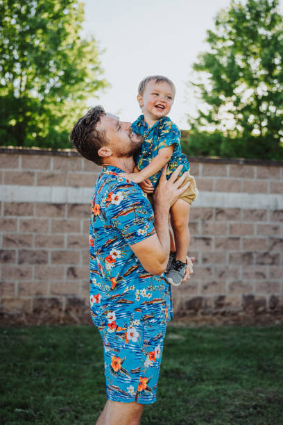 istock Loving father playfully holds his son in the park 2176688203