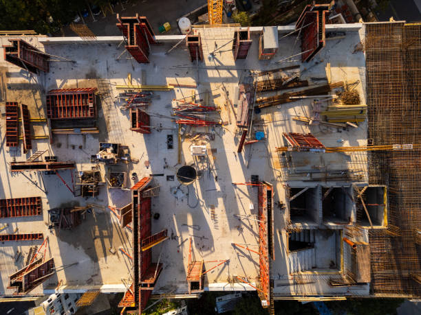 istock A drone video showcasing a top-down view of a construction site. The image captures the building's foundation, scaffolding, and materials, highlighting the early stages of architectural development 2176691396