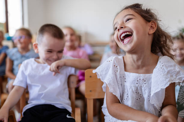 A snapshot of a classroom full of young kids enjoying a joyful moment together, highlighting a positive learning environment and fostering friendships.