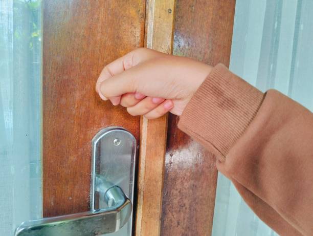 istock Hand knocking on a wooden door 2176692408