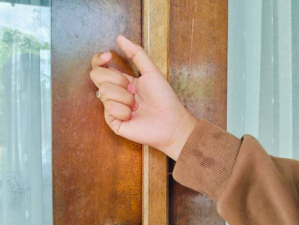 istock Hand knocking on a wooden door 2176692519