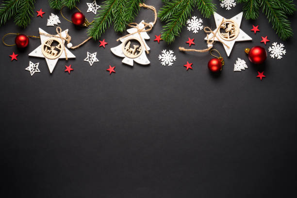 istock Christmas tree with holidays decorations at black background. 2176693001