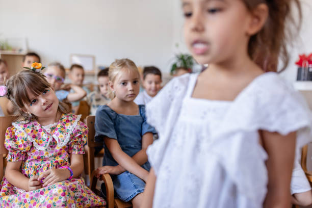 istock Young girl sings confidently while classmates listen intently 2176693487