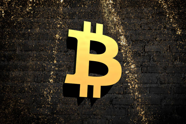 istock Bitcoin symbol on a black brick wall with gold sparks flying 2176697106