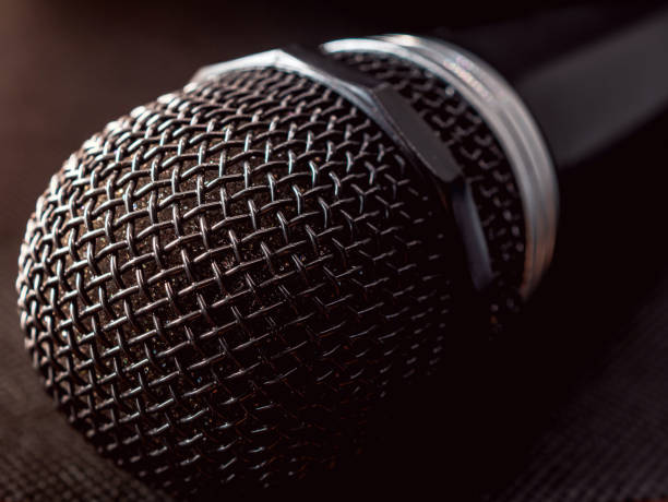 istock Close up of microphone on black background 2176698254