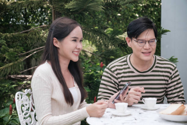 istock Couple Asian looking mobile and very happy 2176700257