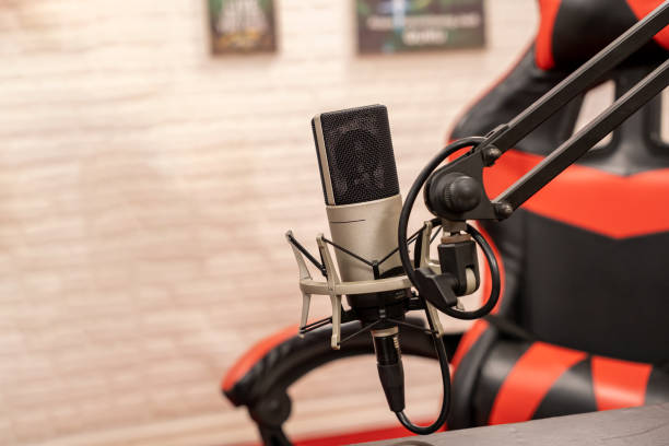 istock A dynamic microphone condenser set up in a modern gaming space with a stylish red and black gaming chair nearby for ultimate comfort 2176700340