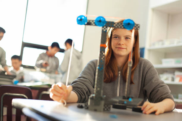 istock Teenage girl in high school classroom making physics construction science engineering technology mathematics STEM project 2176704937