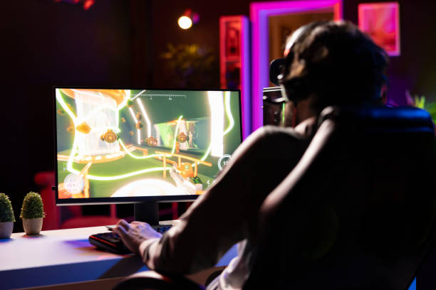 istock Man talks with teammates online while playing video games 2176704946