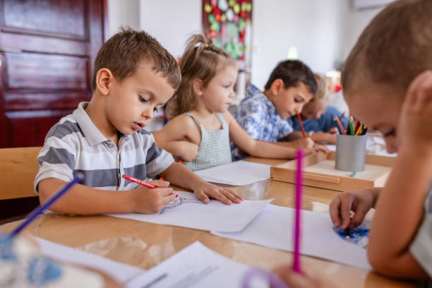 istock Children drawing with colored pencils in a preschool. 2176706378