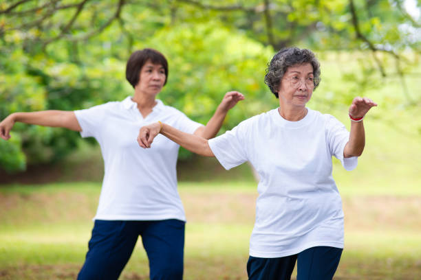 istock Two elderly women practicing Tai Chi movement in the garden 2176711039