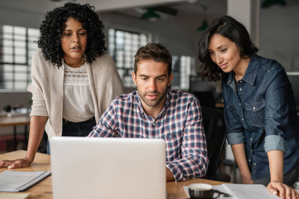 istock Diverse young designers working online with an office laptop 2176711812