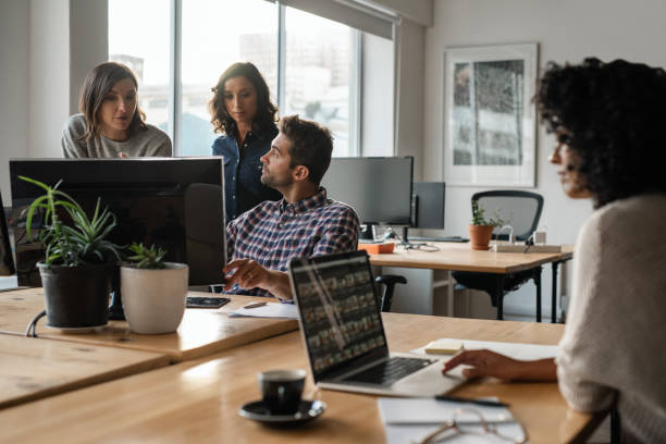 istock Diverse group of young designers working together on a computer 2176713028