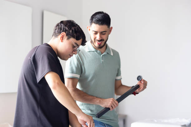 istock Young man watching his partner assembling a piece of furniture 2176717593